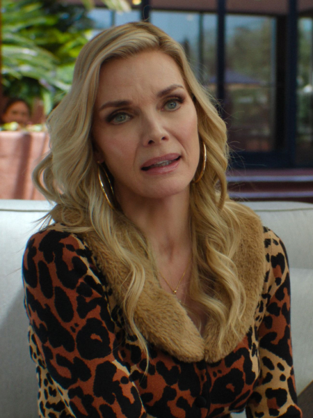 Michelle Pfeiffer as Shyanne in Margo's Got Money Trouble sitting on a couch.